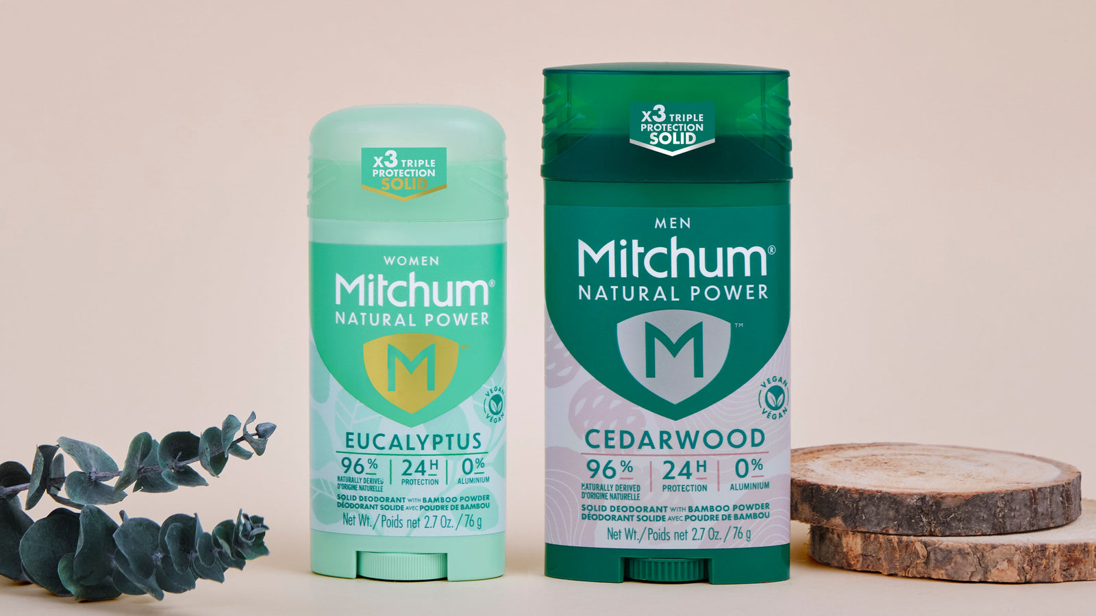 Two Mitchum deodorant products on a light background with eucalyptus leaves.